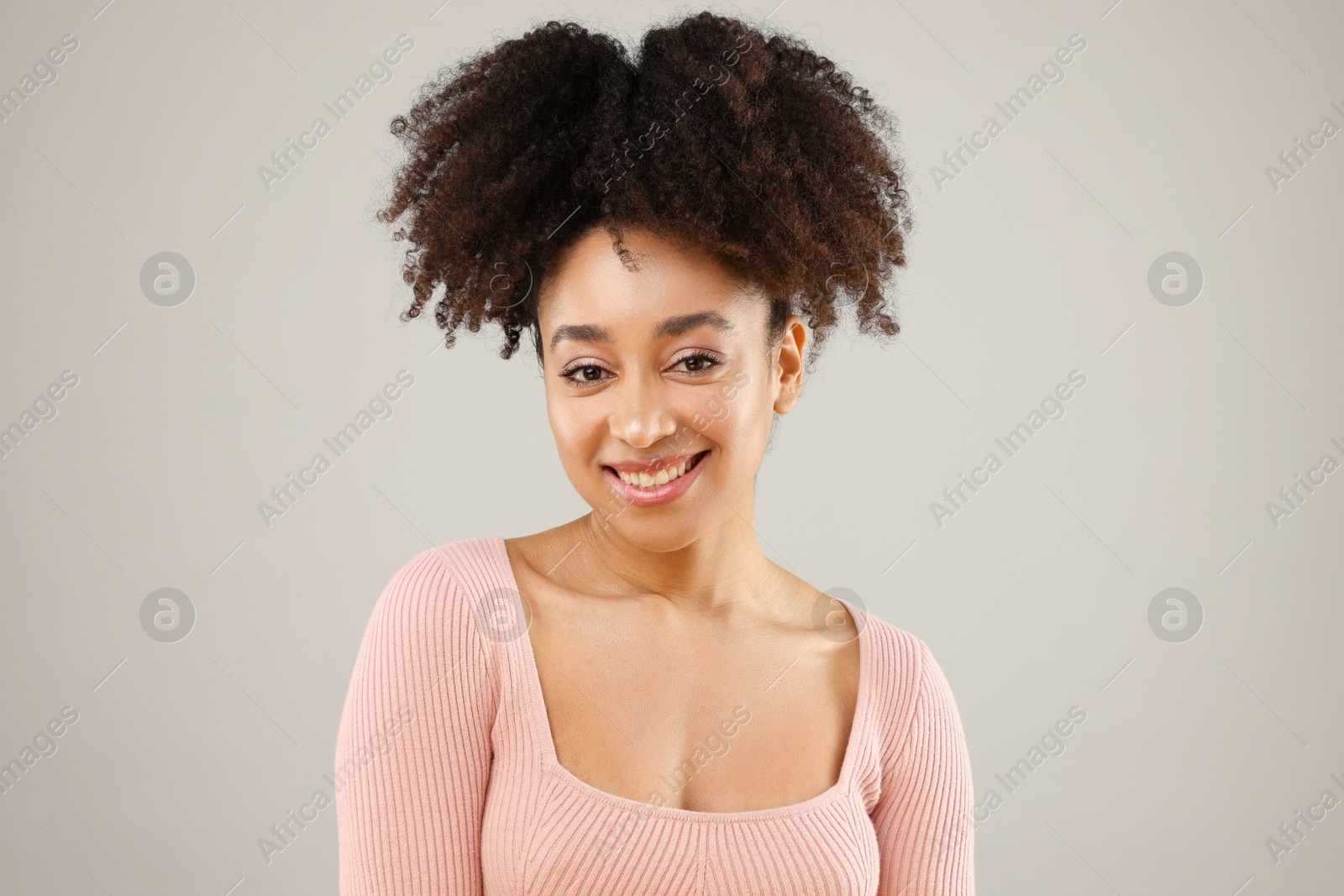 Portrait of beautiful Brazilian woman on gray background Photo of Portrait of beautiful Brazilian woman on gray background