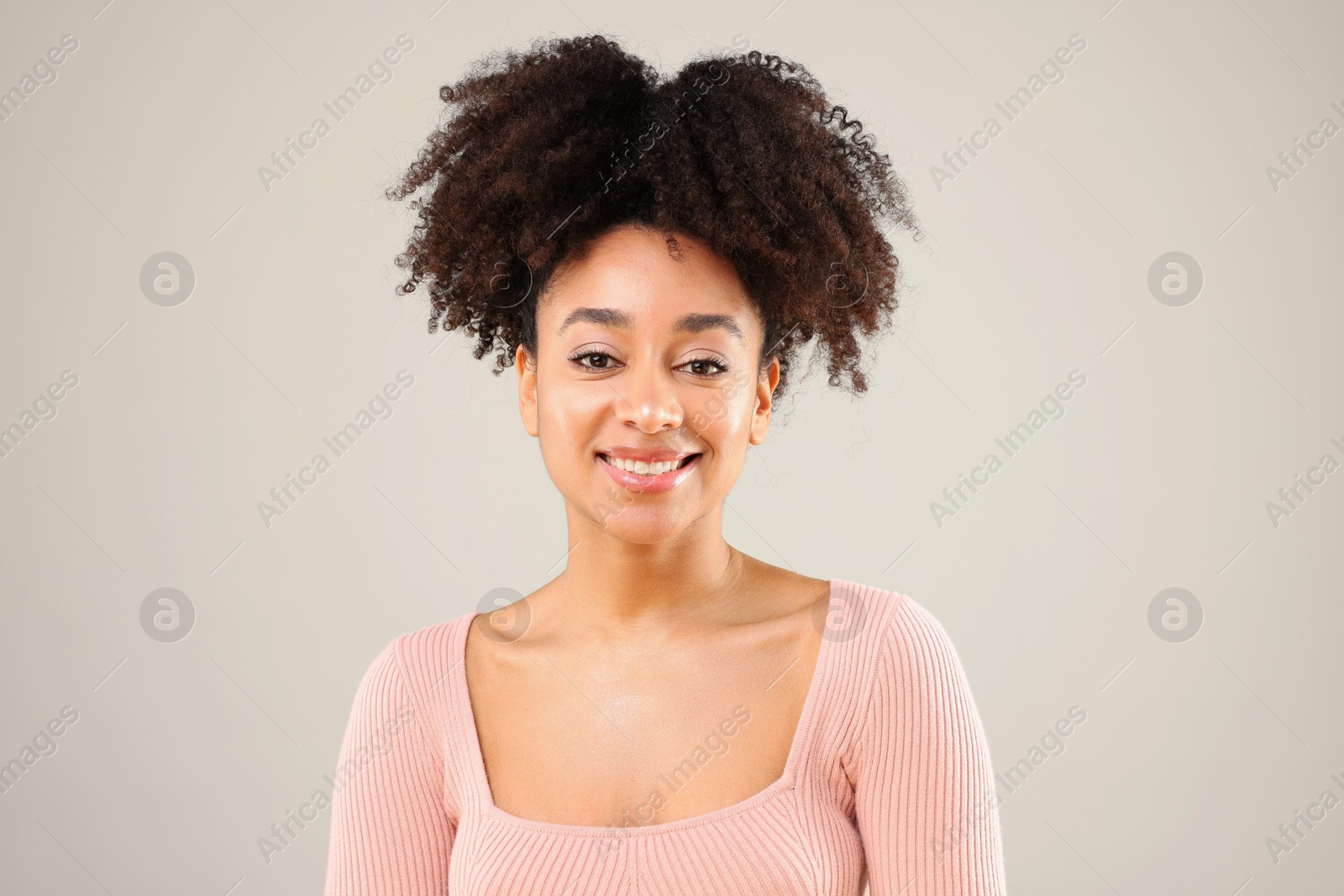 Portrait of beautiful Brazilian woman on gray background Photo of Portrait of beautiful Brazilian woman on gray background