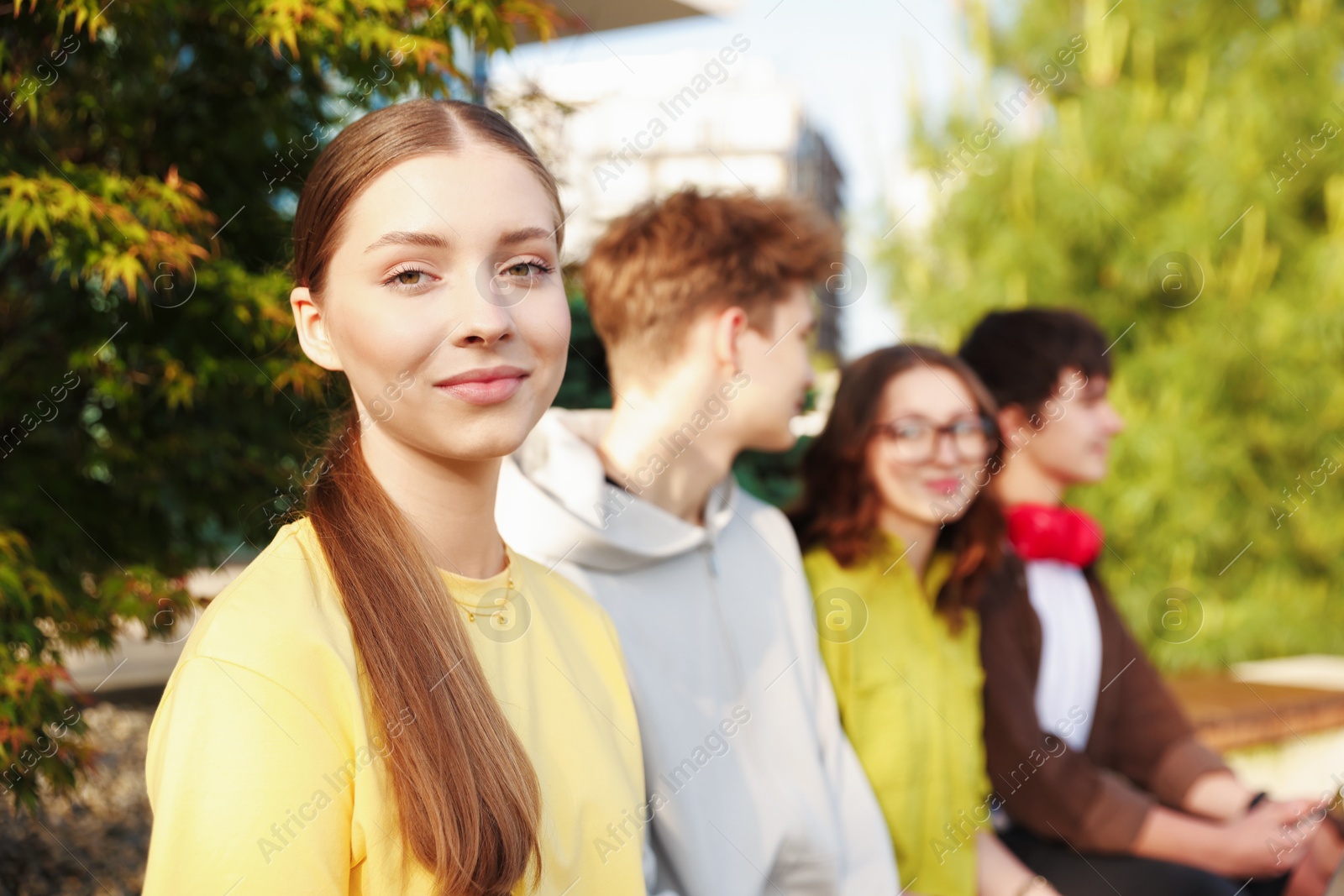 Teenagers spending time together in park, selective focus Photo of Teenagers spending time together in park, selective focus