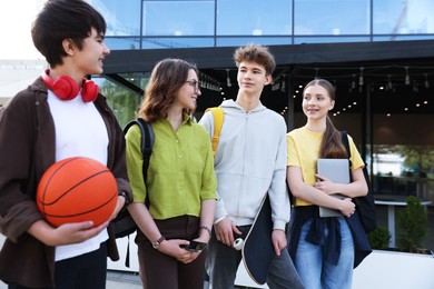 Photo of Group of teenagers spending time together outdoors