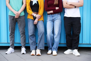 Photo of Group of teenagers near building outdoors, closeup