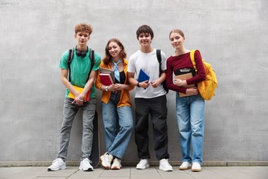 Photo of Group of teenagers posing near building outdoors