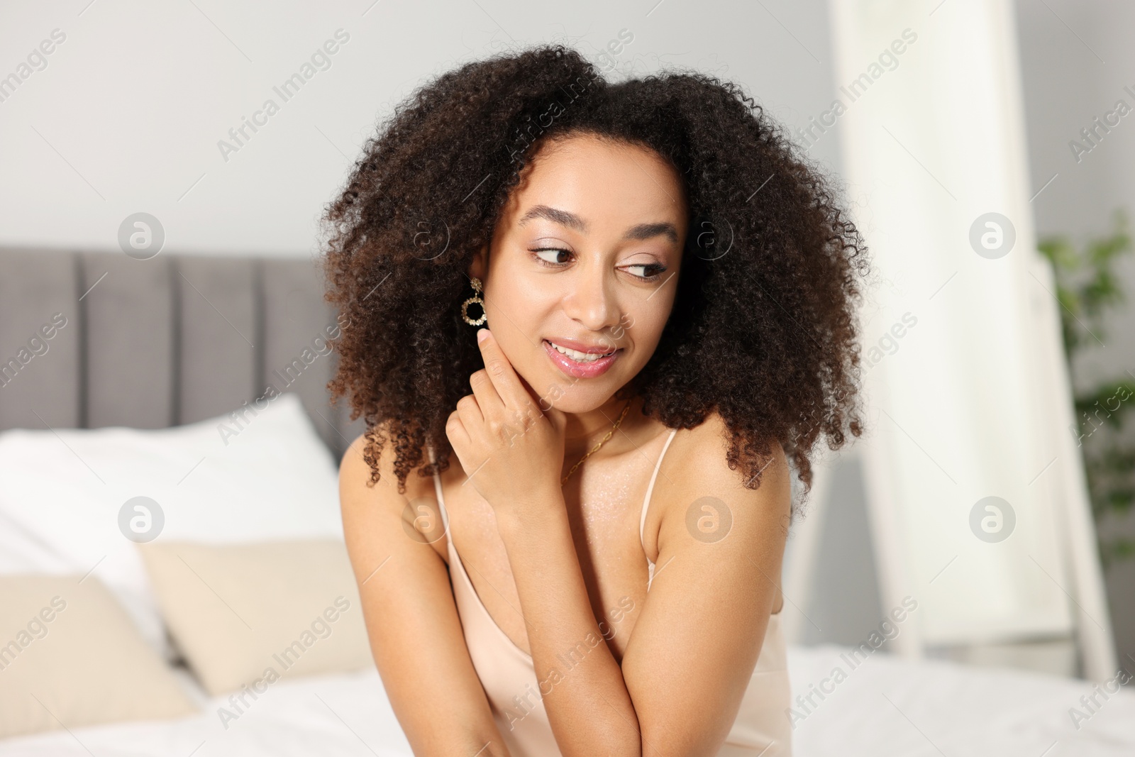 Beautiful smiling Brazilian woman with curly hair indoors Photo of Beautiful smiling Brazilian woman with curly hair indoors
