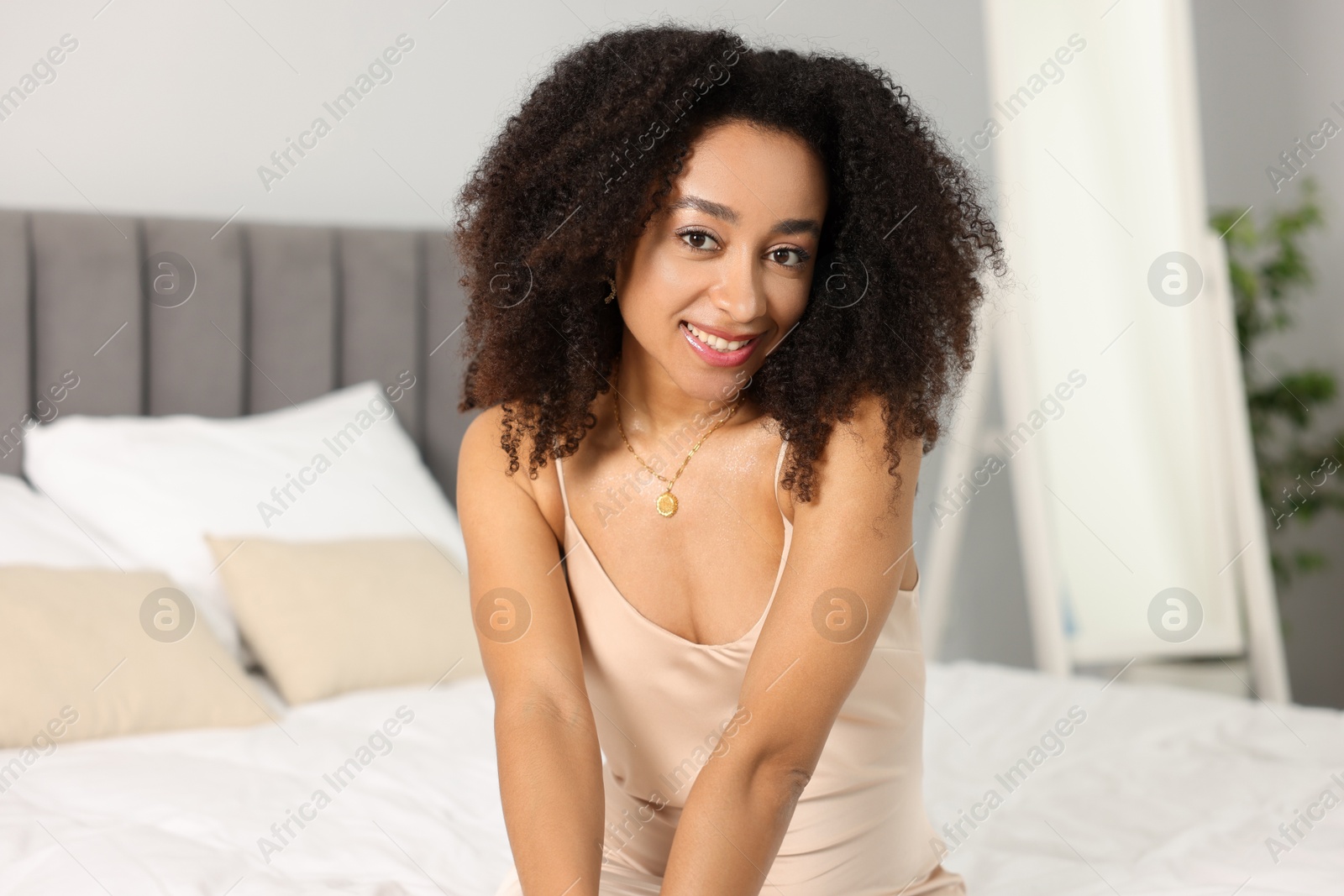 Beautiful smiling Brazilian woman with curly hair indoors Photo of Beautiful smiling Brazilian woman with curly hair indoors