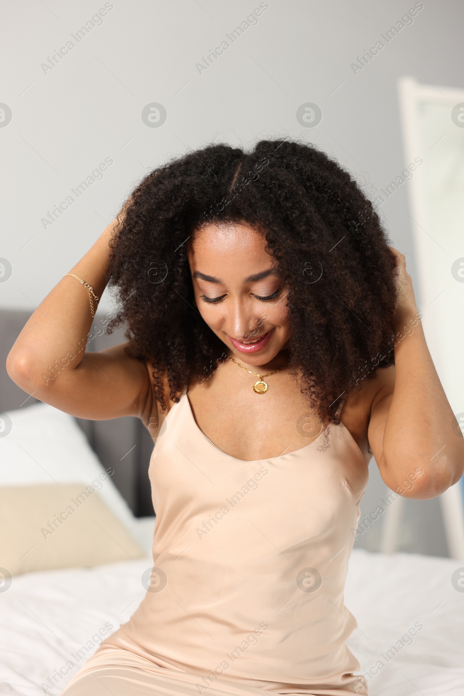 Beautiful smiling Brazilian woman with curly hair indoors Photo of Beautiful smiling Brazilian woman with curly hair indoors