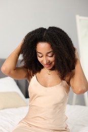 Photo of Beautiful smiling Brazilian woman with curly hair indoors