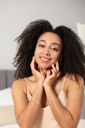 Photo of Beautiful smiling Brazilian woman with curly hair indoors