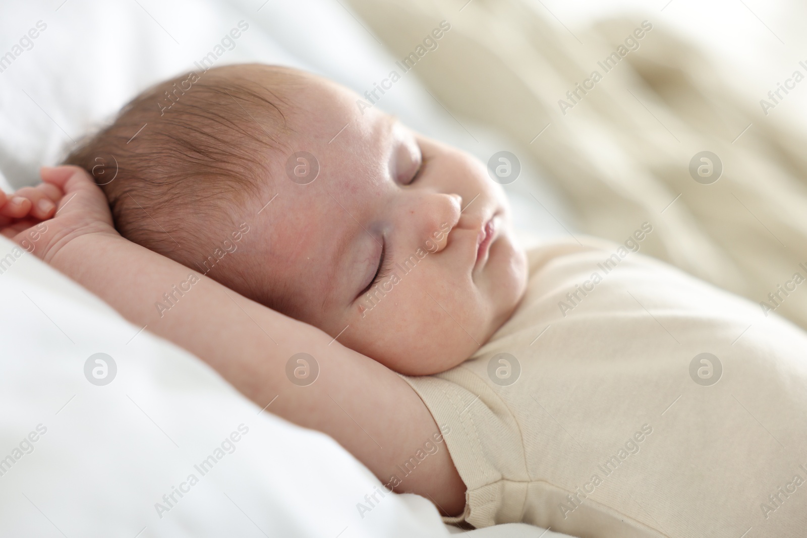 Cute newborn baby sleeping on bed indoors Photo of Cute newborn baby sleeping on bed indoors