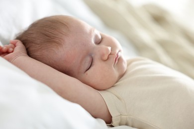Photo of Cute newborn baby sleeping on bed indoors