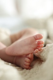 Photo of Cute newborn baby lying on bed indoors, closeup