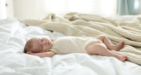 Photo of Cute newborn baby sleeping on bed indoors