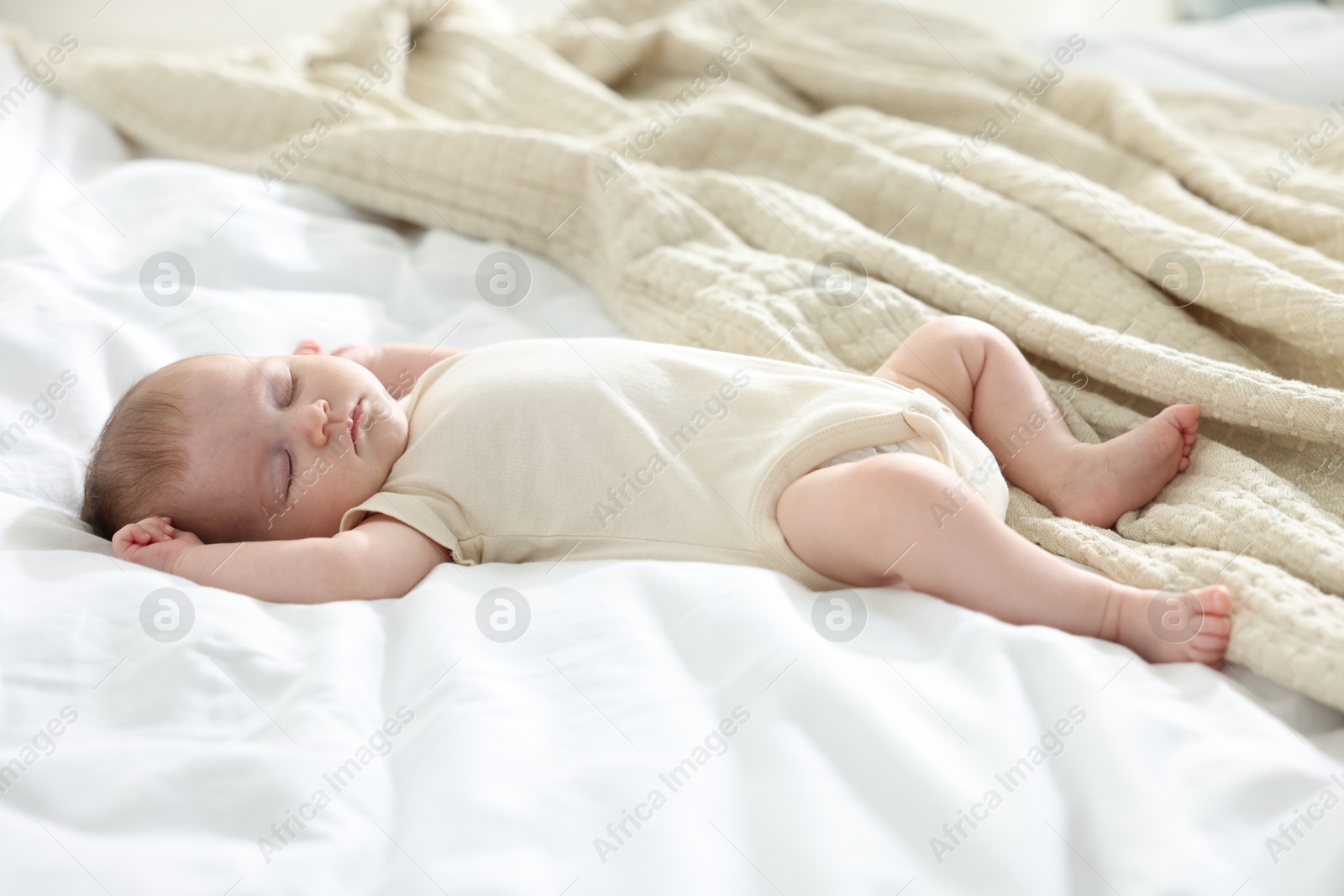 Cute newborn baby sleeping on bed indoors Photo of Cute newborn baby sleeping on bed indoors