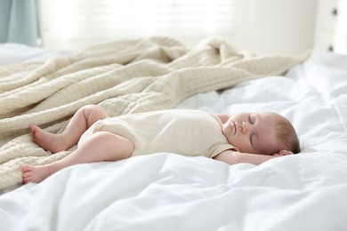 Photo of Cute newborn baby sleeping on bed indoors