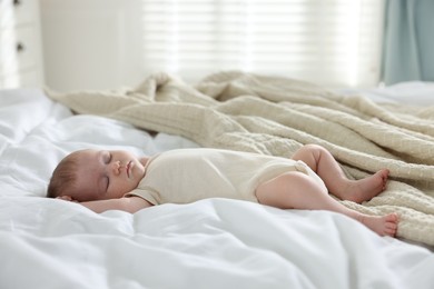 Photo of Cute newborn baby sleeping on bed indoors