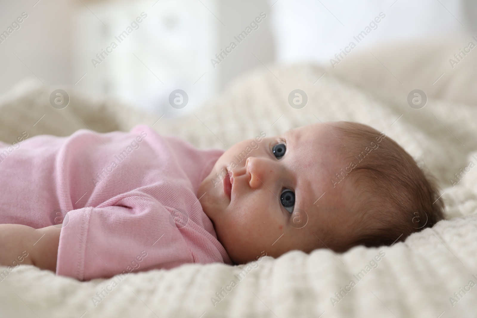 Cute newborn baby lying on bed indoors Photo of Cute newborn baby lying on bed indoors