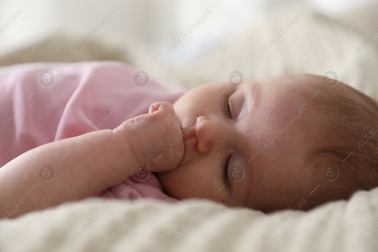 Photo of Cute newborn baby sleeping on bed indoors