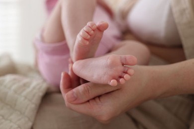Photo of Mother with her newborn baby indoors, closeup