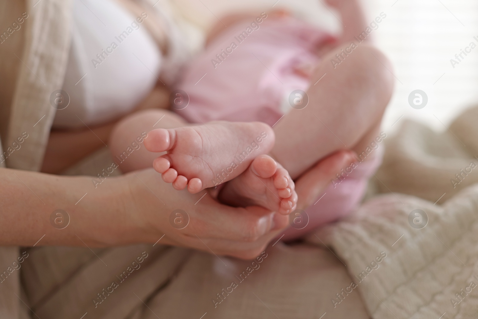 Mother with her newborn baby indoors, closeup Photo of Mother with her newborn baby indoors, closeup