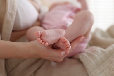 Photo of Mother with her newborn baby indoors, closeup