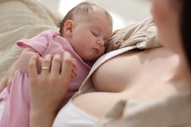 Photo of Mother with her newborn baby indoors, above view