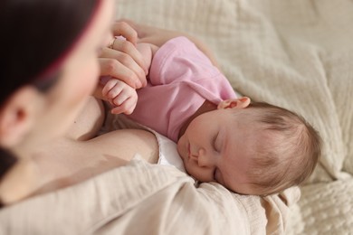 Photo of Mother with her newborn baby indoors, above view