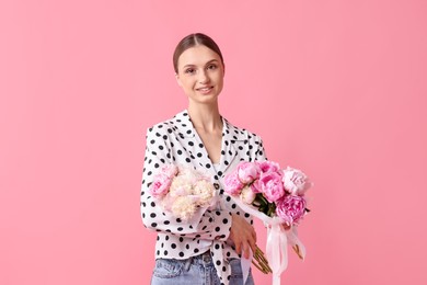 Photo of Woman with beautiful bouquets of peonies on pink background
