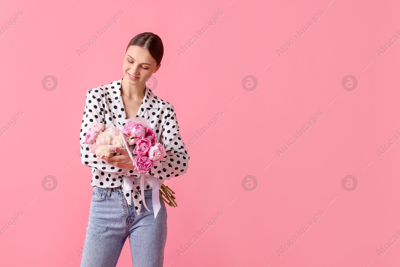 Woman with beautiful bouquets of peonies on pink background, space for text Photo of Woman with beautiful bouquets of peonies on pink background, space for text