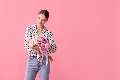 Photo of Woman with beautiful bouquets of peonies on pink background, space for text