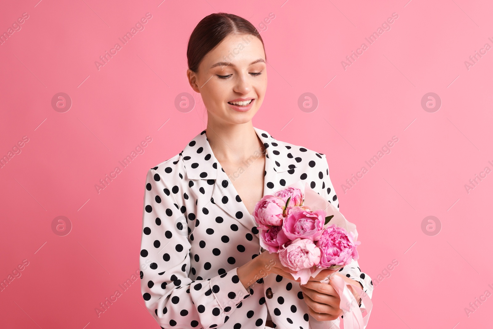Woman with beautiful bouquet of peonies on pink background Photo of Woman with beautiful bouquet of peonies on pink background