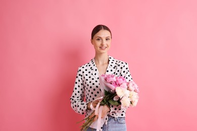 Photo of Woman with beautiful bouquets of peonies on pink background