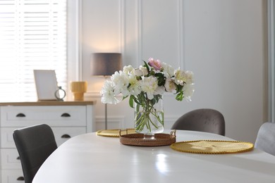 Photo of Beautiful table setting with vase of flowers in dining room