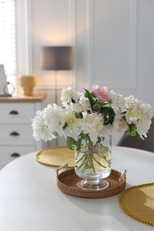 Photo of Beautiful table setting with vase of flowers in dining room