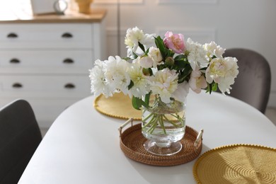 Photo of Beautiful table setting with vase of flowers in dining room