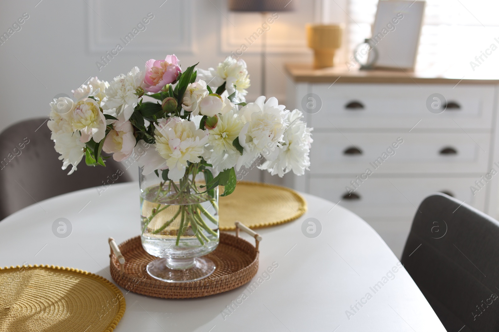 Beautiful table setting with vase of flowers in dining room, space for text Photo of Beautiful table setting with vase of flowers in dining room, space for text