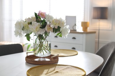 Photo of Beautiful table setting with vase of flowers in dining room