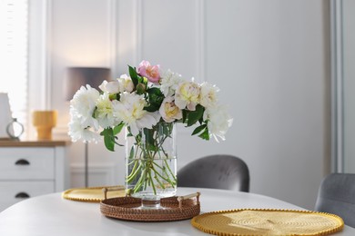 Photo of Beautiful table setting with vase of flowers in dining room, space for text