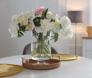 Photo of Beautiful table setting with vase of flowers in dining room