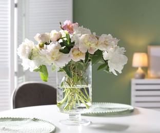 Photo of Beautiful table setting with vase of flowers in dining room