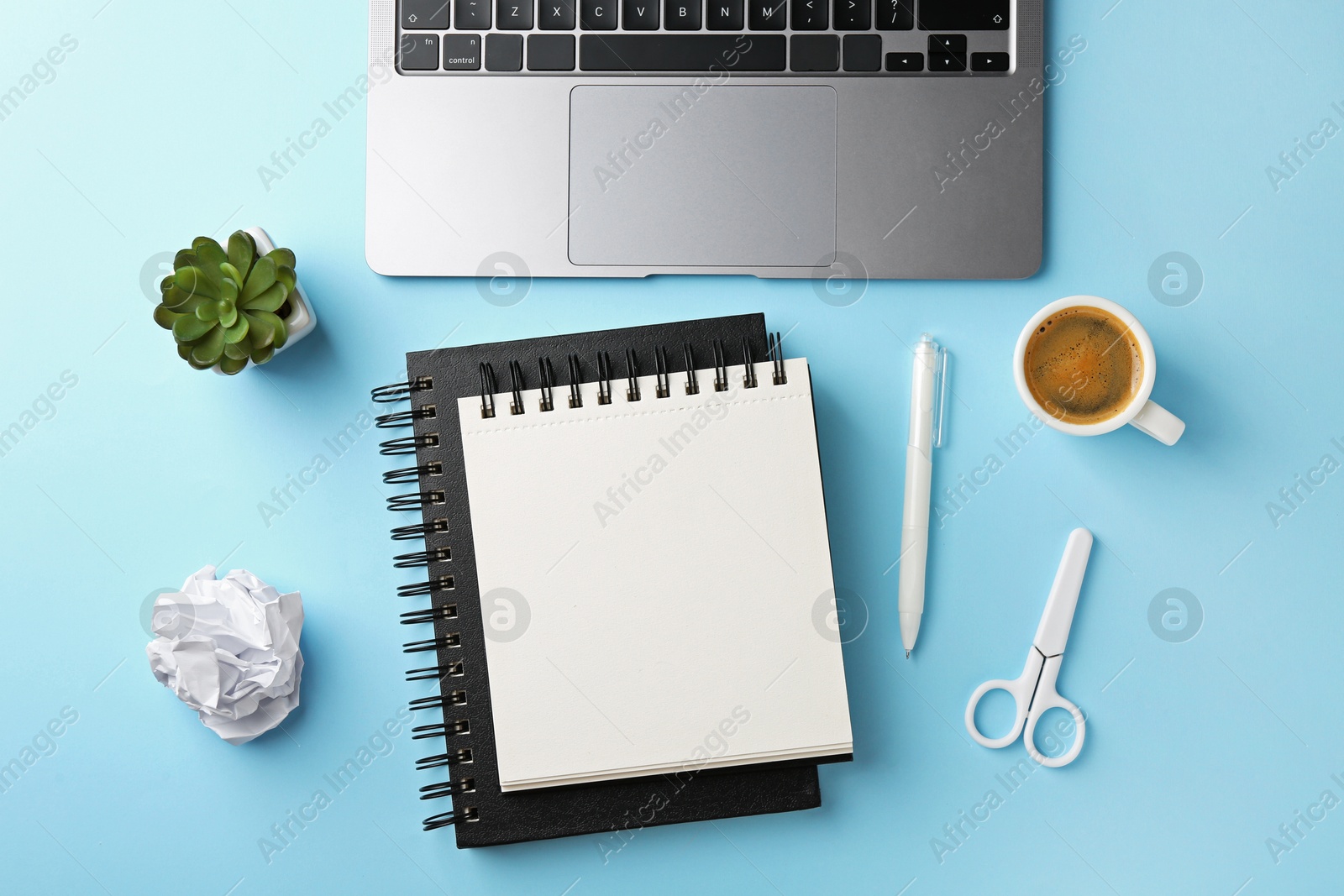 Notebooks, other stationery, laptop, glasses, crumpled paper and coffee on light blue background, flat lay Photo of Notebooks, other stationery, laptop, glasses, crumpled paper and coffee on light blue background, flat lay