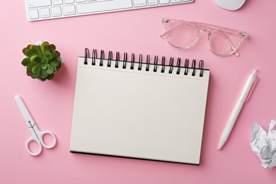 Photo of Notebook, other stationery, glasses, floral decor, computer keyboard and mouse on pink background, flat lay