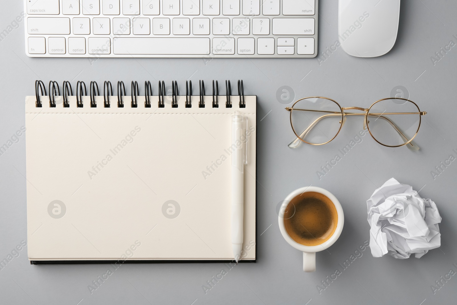 Notebook, pen, crumpled paper, coffee, computer keyboard and mouse on grey background, flat lay Photo of Notebook, pen, crumpled paper, coffee, computer keyboard and mouse on grey background, flat lay