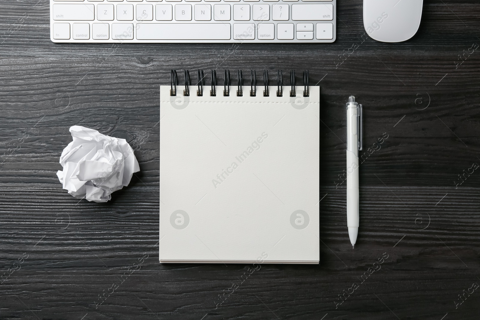 Notebook, pen, crumpled paper, computer keyboard and mouse on black wooden table, flat lay Photo of Notebook, pen, crumpled paper, computer keyboard and mouse on black wooden table, flat lay