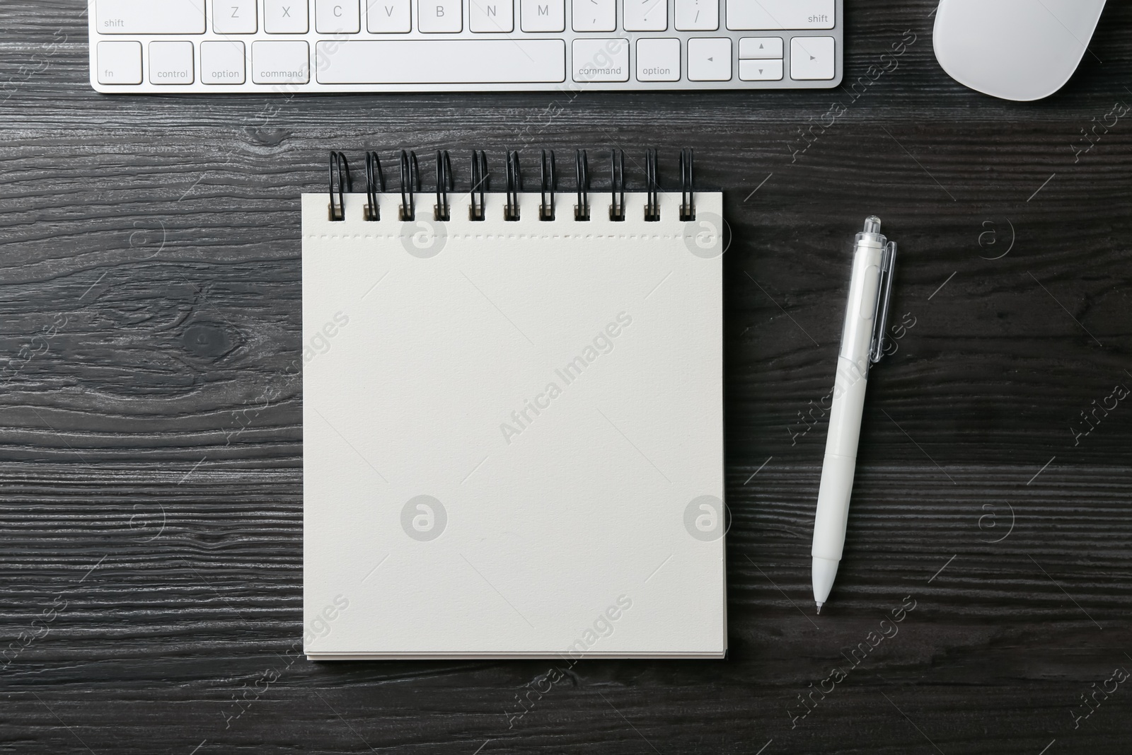 Notebook, pen, computer keyboard and mouse on black wooden table, flat lay Photo of Notebook, pen, computer keyboard and mouse on black wooden table, flat lay
