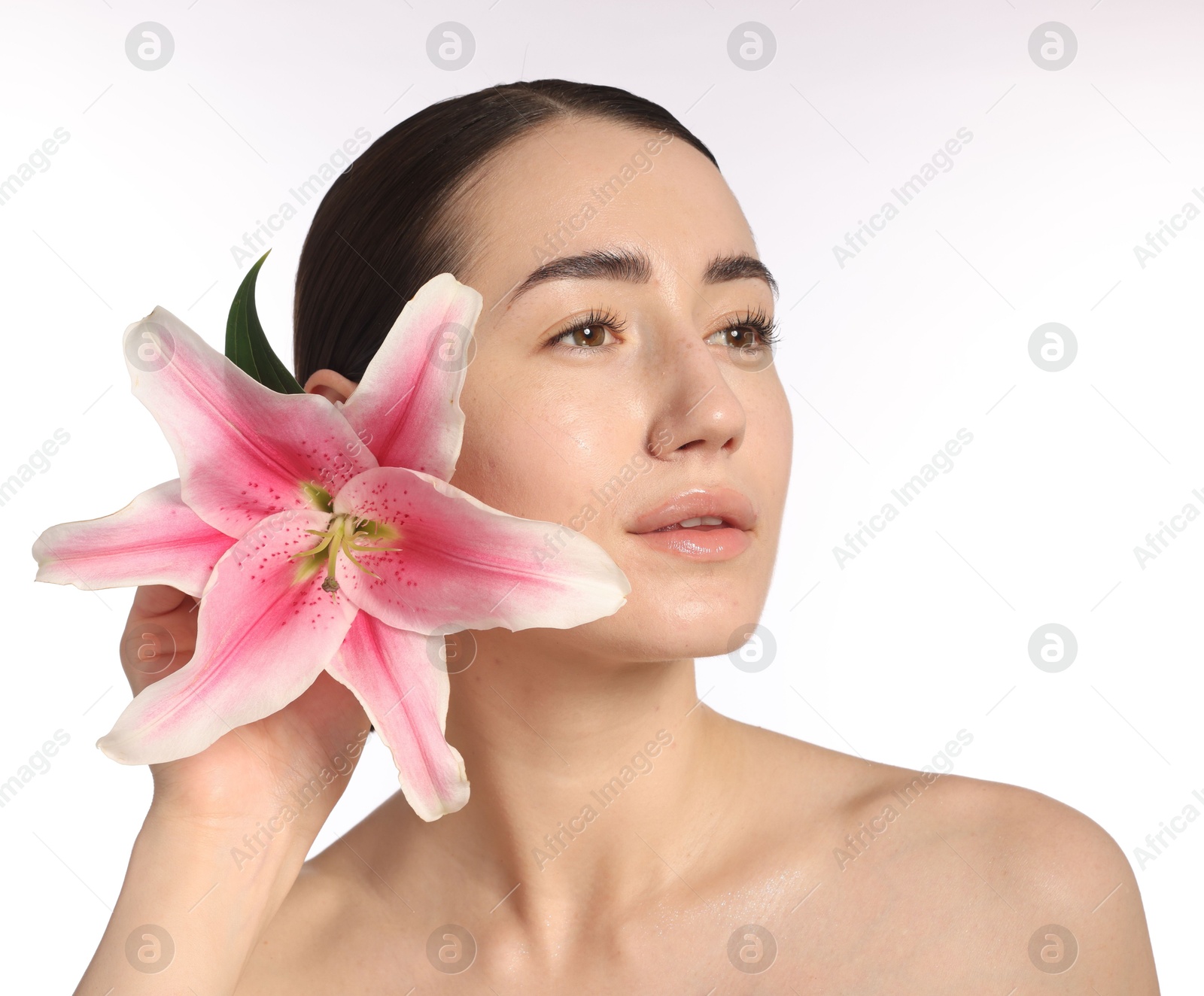 Beautiful woman with lily flower after spa treatment on white background, closeup Photo of Beautiful woman with lily flower after spa treatment on white background, closeup