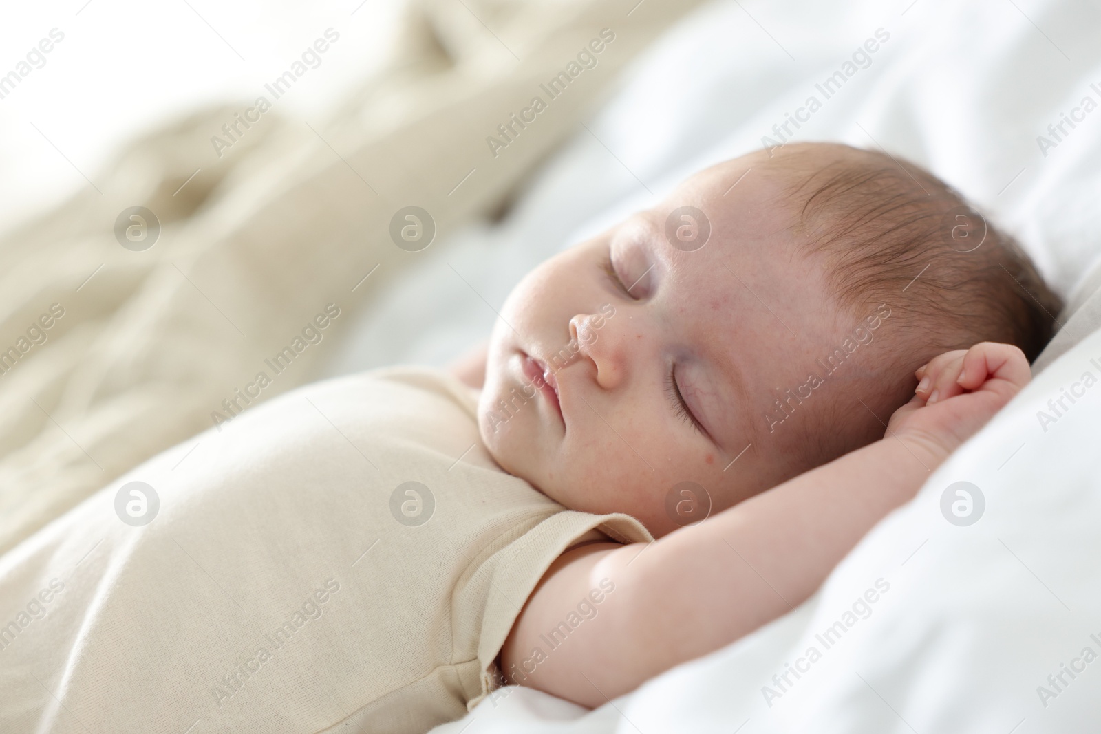 Photo of Cute newborn baby sleeping on bed indoors