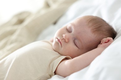 Photo of Cute newborn baby sleeping on bed indoors