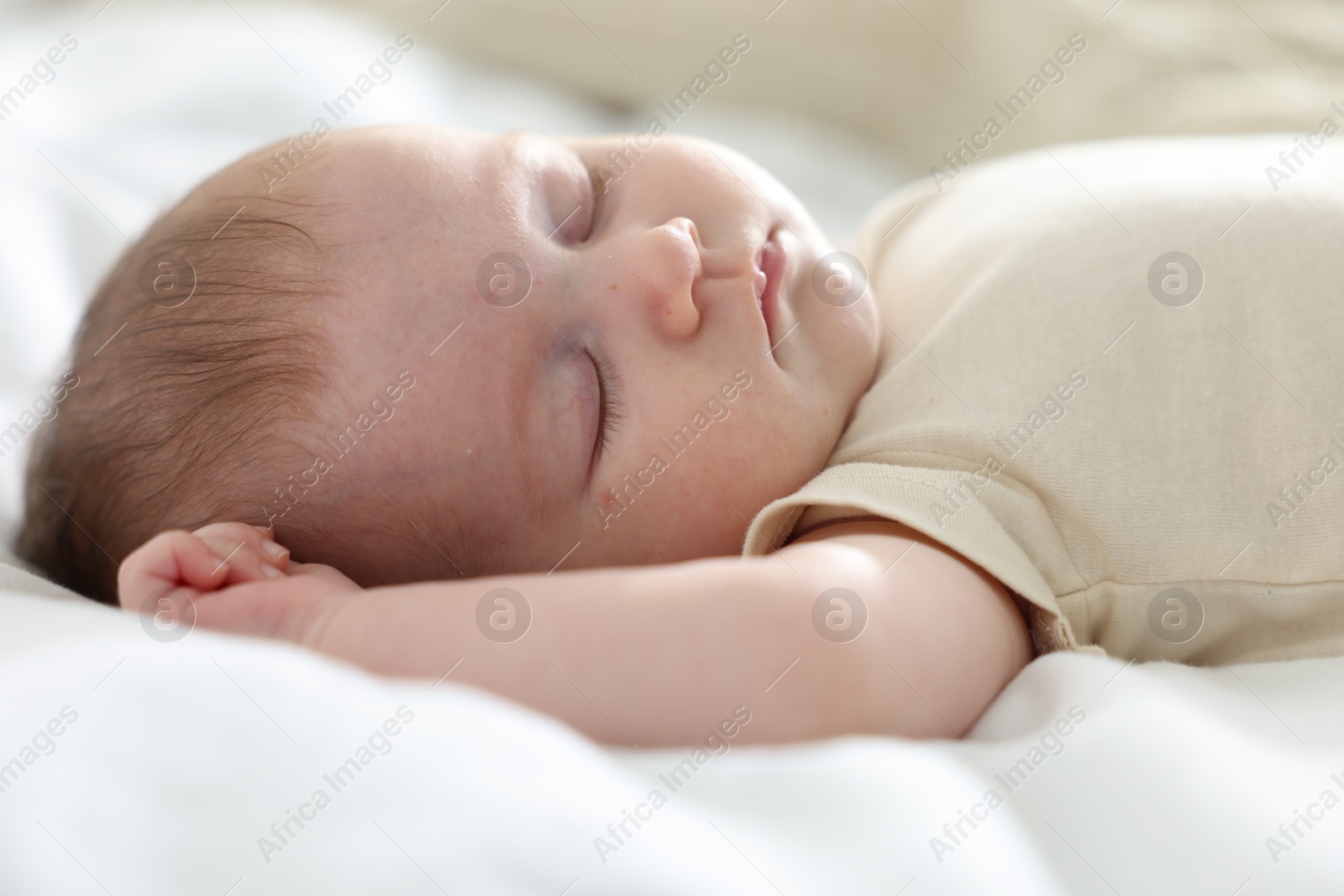 Photo of Cute newborn baby sleeping on bed indoors
