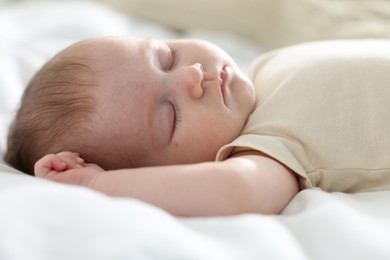 Photo of Cute newborn baby sleeping on bed indoors