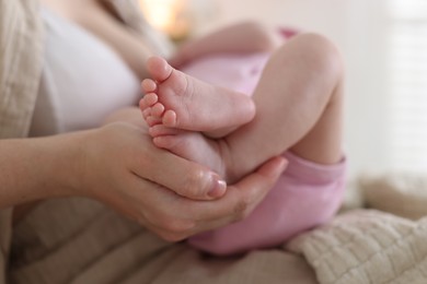 Photo of Mother with her newborn baby indoors, closeup