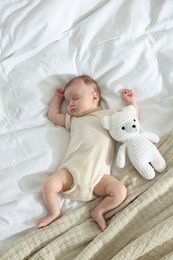 Photo of Cute newborn baby sleeping on bed indoors, top view